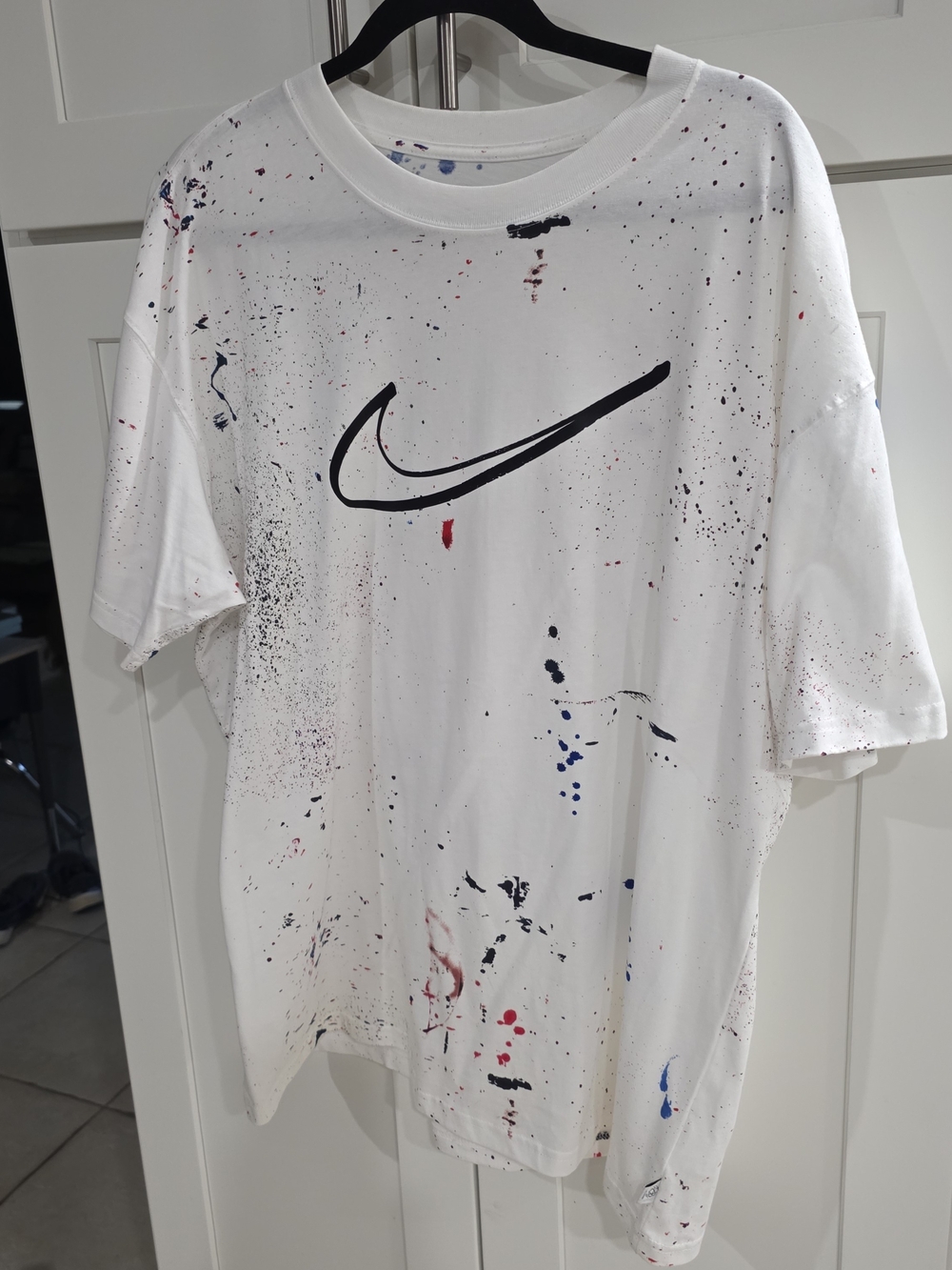 Nike White Tee with Black Logo and Blue Paint Spots